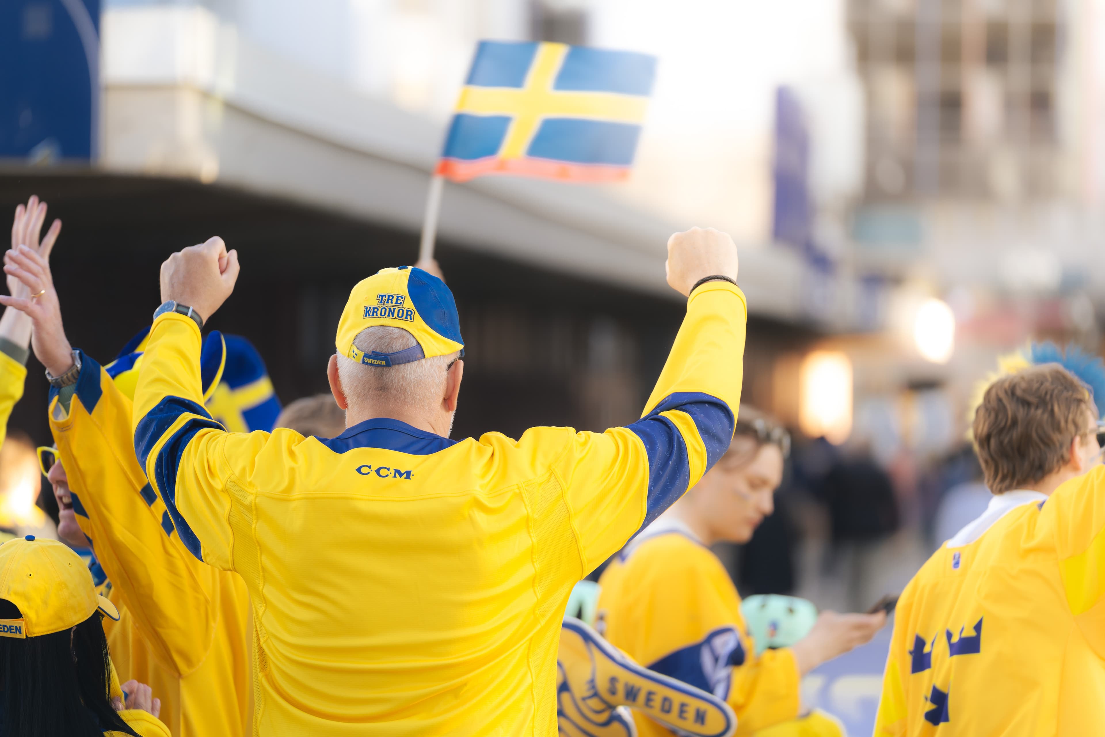 Ice hockey fans wearing swedish national team shirts.